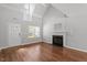 Open living room with hardwood flooring, fireplace, and lots of natural light at 15 Epping Ct, Durham, NC 27703