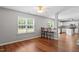 Open living room with a view of the kitchen, hardwood flooring, and neutral paint at 15 Epping Ct, Durham, NC 27703