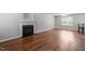 Spacious living room featuring a fireplace, hardwood flooring, and neutral paint at 15 Epping Ct, Durham, NC 27703