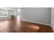 Open living room with a view of the backyard, hardwood flooring, and neutral paint at 15 Epping Ct, Durham, NC 27703