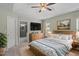 Spacious main bedroom with a ceiling fan, ensuite bathroom, and a calming color palette at 15 Epping Ct, Durham, NC 27703