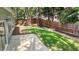 Backyard with a lush lawn, wooden fence, mature trees, and a concrete patio, perfect for relaxing at 1608 Hayesville Dr, Fuquay Varina, NC 27526