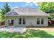 Backyard with a well-maintained lawn, mature trees, and a concrete patio ideal for entertaining at 1608 Hayesville Dr, Fuquay Varina, NC 27526