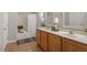 Bright bathroom features a double vanity, wooden cabinets, and decorative accents at 1608 Hayesville Dr, Fuquay Varina, NC 27526