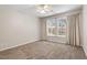 Bedroom featuring neutral carpet, neutral walls and curtains, and view to backyard at 1608 Hayesville Dr, Fuquay Varina, NC 27526