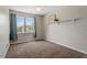 Bright bedroom with two windows, neutral paint, and a cozy carpet at 1608 Hayesville Dr, Fuquay Varina, NC 27526