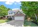 Charming two-story home with stone accents, manicured lawn, and inviting front porch at 1608 Hayesville Dr, Fuquay Varina, NC 27526