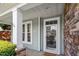 Inviting front entrance with stone detail, classic trim and landscaping at 1608 Hayesville Dr, Fuquay Varina, NC 27526