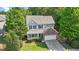 Charming two-story home with a stone accent, well-manicured lawn, surrounded by mature trees at 1608 Hayesville Dr, Fuquay Varina, NC 27526