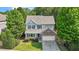 Charming two-story home with a stone accent, well-manicured lawn, surrounded by mature trees at 1608 Hayesville Dr, Fuquay Varina, NC 27526
