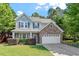Charming two-story home with a stone accent, well-manicured lawn, and attached two-car garage at 1608 Hayesville Dr, Fuquay Varina, NC 27526