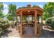 Cozy wooden gazebo with built-in benches and a view of the neighborhood at 1608 Hayesville Dr, Fuquay Varina, NC 27526