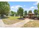 A wooden gazebo with seating area and sidewalk located in a grassy area at 1608 Hayesville Dr, Fuquay Varina, NC 27526