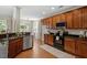 Modern kitchen featuring wooden cabinets, granite countertops, and stainless steel appliances at 1608 Hayesville Dr, Fuquay Varina, NC 27526