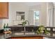 Close-up of the kitchen sink with granite countertops, with view to living area at 1608 Hayesville Dr, Fuquay Varina, NC 27526