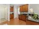 Well-appointed kitchen featuring wooden cabinets, granite countertops, and stainless steel sink at 1608 Hayesville Dr, Fuquay Varina, NC 27526