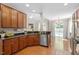 Bright kitchen with hardwood floors, breakfast bar, and stainless steel appliances at 1608 Hayesville Dr, Fuquay Varina, NC 27526