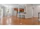 Open-concept living room with hardwood floors, breakfast bar, and lots of natural light at 1608 Hayesville Dr, Fuquay Varina, NC 27526