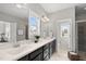 Bathroom features dual sinks with black cabinetry, neutral walls, and natural light at 1616 Silo Ridge Dr, Wake Forest, NC 27587