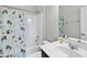 Bright bathroom featuring a tub and shower combo with a charming, plant-themed shower curtain at 1616 Silo Ridge Dr, Wake Forest, NC 27587