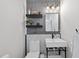Modern powder room with mosaic tile accent wall, floating shelves, and square sink and toilet at 1616 Silo Ridge Dr, Wake Forest, NC 27587