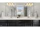 Bathroom features dual sinks with black cabinetry, neutral walls, and natural light at 1616 Silo Ridge Dr, Wake Forest, NC 27587