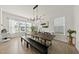 Bright dining area with a long table, stylish light fixture, and lots of natural light at 1616 Silo Ridge Dr, Wake Forest, NC 27587