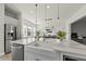 Farmhouse sink and marble island with pendant lights are focal points in this bright open concept kitchen at 1616 Silo Ridge Dr, Wake Forest, NC 27587