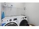 Efficient laundry room showcasing a modern washer and dryer set with overhead storage shelves at 1616 Silo Ridge Dr, Wake Forest, NC 27587