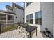 Cozy outdoor patio with a table and chairs, ideal for dining and relaxing, with adjacent home at 1616 Silo Ridge Dr, Wake Forest, NC 27587