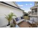 Relaxing outdoor seating area on a patio, featuring comfortable couch and chair with a rug at 1616 Silo Ridge Dr, Wake Forest, NC 27587
