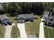 Aerial view of home with driveway, well-manicured lawns, and mature trees at 199 Courtney Ln, Dunn, NC 28334