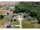 Neighborhood aerial view, showing a home with mature trees, pond, and well-manicured lawns at 199 Courtney Ln, Dunn, NC 28334