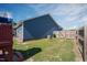 Fenced backyard with play equipment, storage shed, and ample green space at 199 Courtney Ln, Dunn, NC 28334