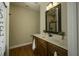 Clean bathroom features wood cabinets, marble countertop, and decorative mirror at 199 Courtney Ln, Dunn, NC 28334