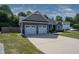 Charming home with a two-car garage, landscaped yard, and well-maintained lawn and stone accents at 199 Courtney Ln, Dunn, NC 28334
