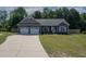 Charming single-story home featuring a two-car garage, landscaped front yard, and inviting entrance at 199 Courtney Ln, Dunn, NC 28334