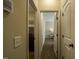 Hallway view of a laundry room and a bedroom with a white bedside table at 199 Courtney Ln, Dunn, NC 28334
