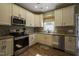 Modern kitchen featuring white cabinets, stainless steel appliances, and granite countertops at 199 Courtney Ln, Dunn, NC 28334