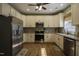 Well-lit kitchen features stainless steel appliances and updated cabinets, backsplash, and countertops at 199 Courtney Ln, Dunn, NC 28334