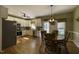 Bright eat-in kitchen featuring white cabinets, stainless steel appliances, and a wooden dining table at 199 Courtney Ln, Dunn, NC 28334