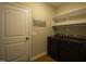 Functional laundry room featuring a black washer and dryer with white shelving at 199 Courtney Ln, Dunn, NC 28334