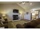 Open living space features a vaulted ceiling, fireplace, and access to the kitchen at 199 Courtney Ln, Dunn, NC 28334