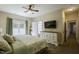 Relaxing main bedroom features a ceiling fan, a TV, and a comfy bed with a light green comforter at 199 Courtney Ln, Dunn, NC 28334