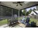 Relaxing screened porch with seating, dining area, and view of the backyard and storage shed at 199 Courtney Ln, Dunn, NC 28334