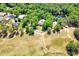 Aerial view shows the location of the property with a pond surrounded by lush greenery at 206 Kittys Ln, Erwin, NC 28339