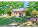 Spacious backyard with lush green lawn, brick patio, and charming brick home exterior at 206 Kittys Ln, Erwin, NC 28339