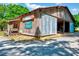 Rustic barn with covered porch and open bay, showcasing country charm and functional design at 206 Kittys Ln, Erwin, NC 28339