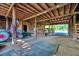 Spacious barn interior featuring wooden beams, tractor, and ample storage space at 206 Kittys Ln, Erwin, NC 28339