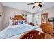 Charming bedroom with wood furnishings, colorful pillows, and natural light from a window at 206 Kittys Ln, Erwin, NC 28339